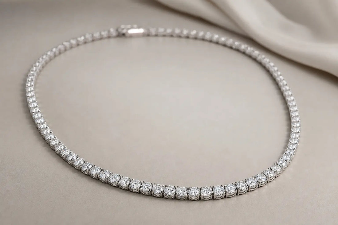 Women's diamond tennis necklace photographed on a neutral background