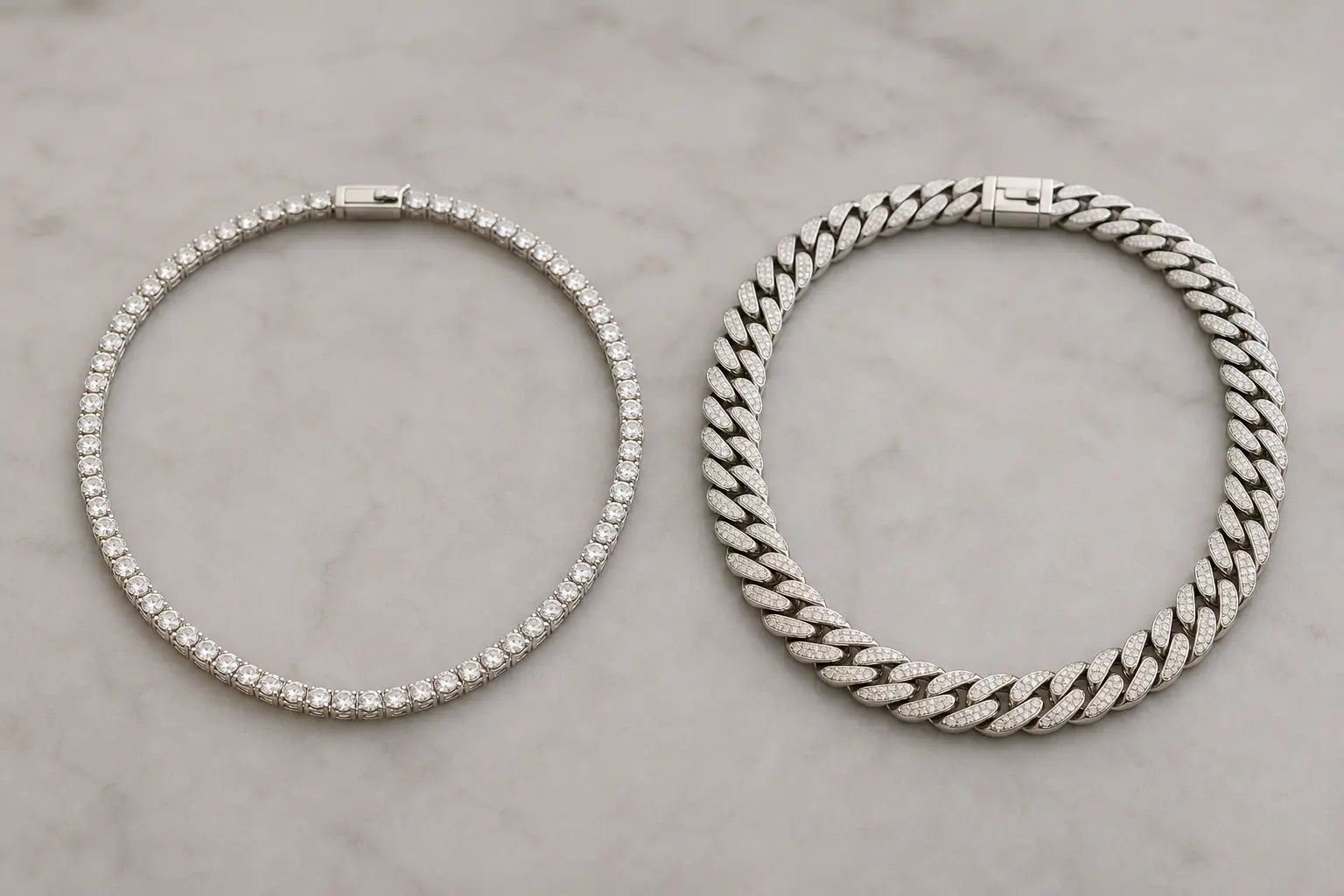 Diamond tennis necklace and Cuban link chain displayed side by side on a neutral surface