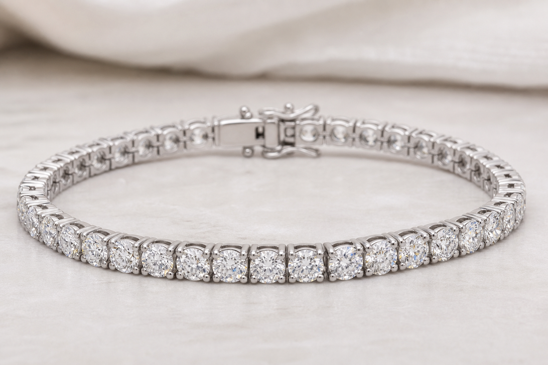 Diamond tennis bracelet resting in a curved line on a neutral surface