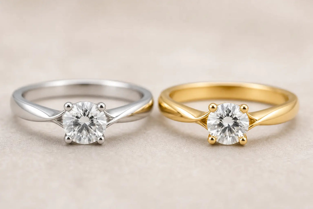 Two diamond engagement rings side by side, one in platinum and one in gold