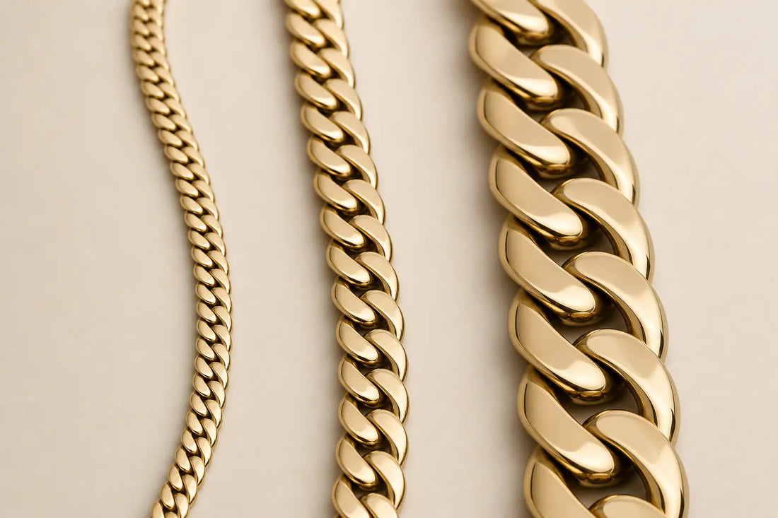 Three Cuban link chains in different widths displayed side by side on a neutral background