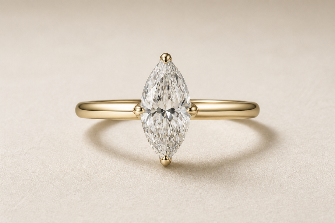Marquise cut diamond ring with an elongated center stone and pointed ends on a neutral background.