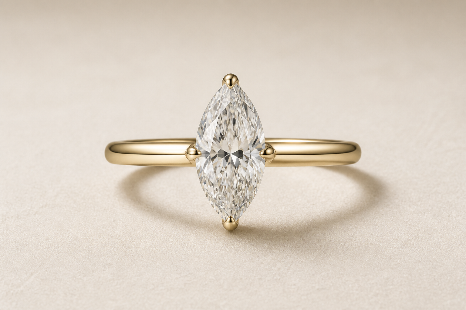 Marquise cut diamond ring with an elongated center stone and pointed ends on a neutral background.