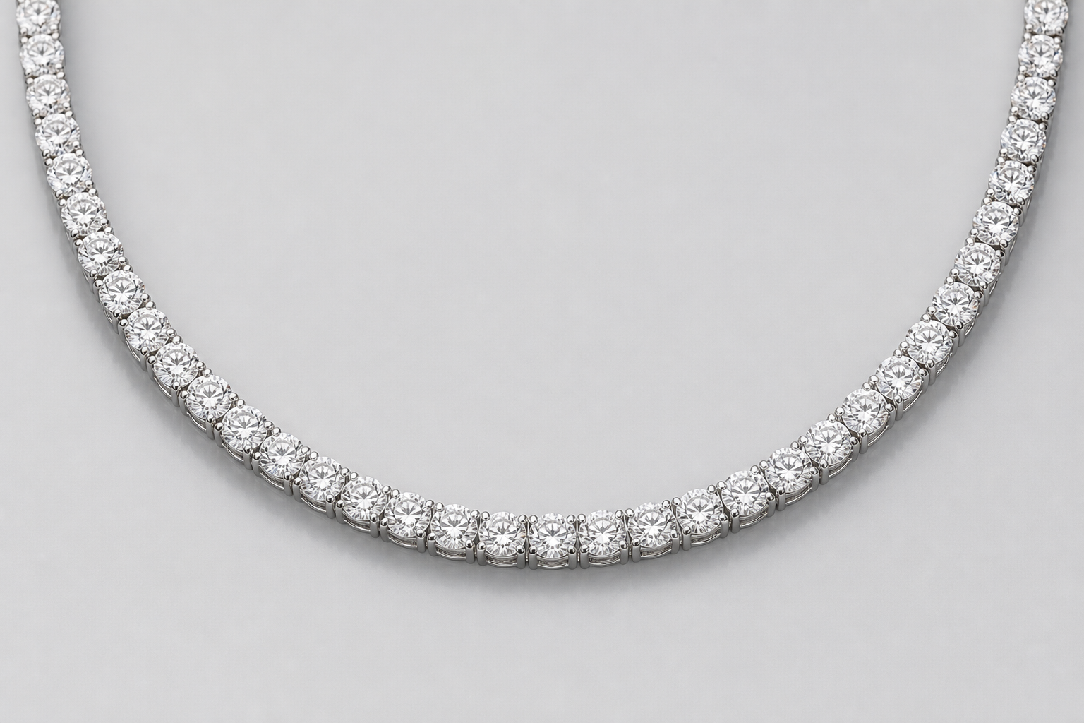 Platinum diamond tennis necklace on a light gray background