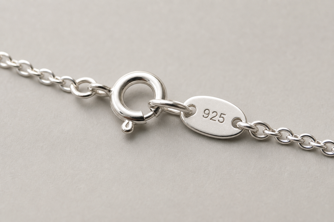 Close-up of a sterling silver necklace clasp with a 925 stamp