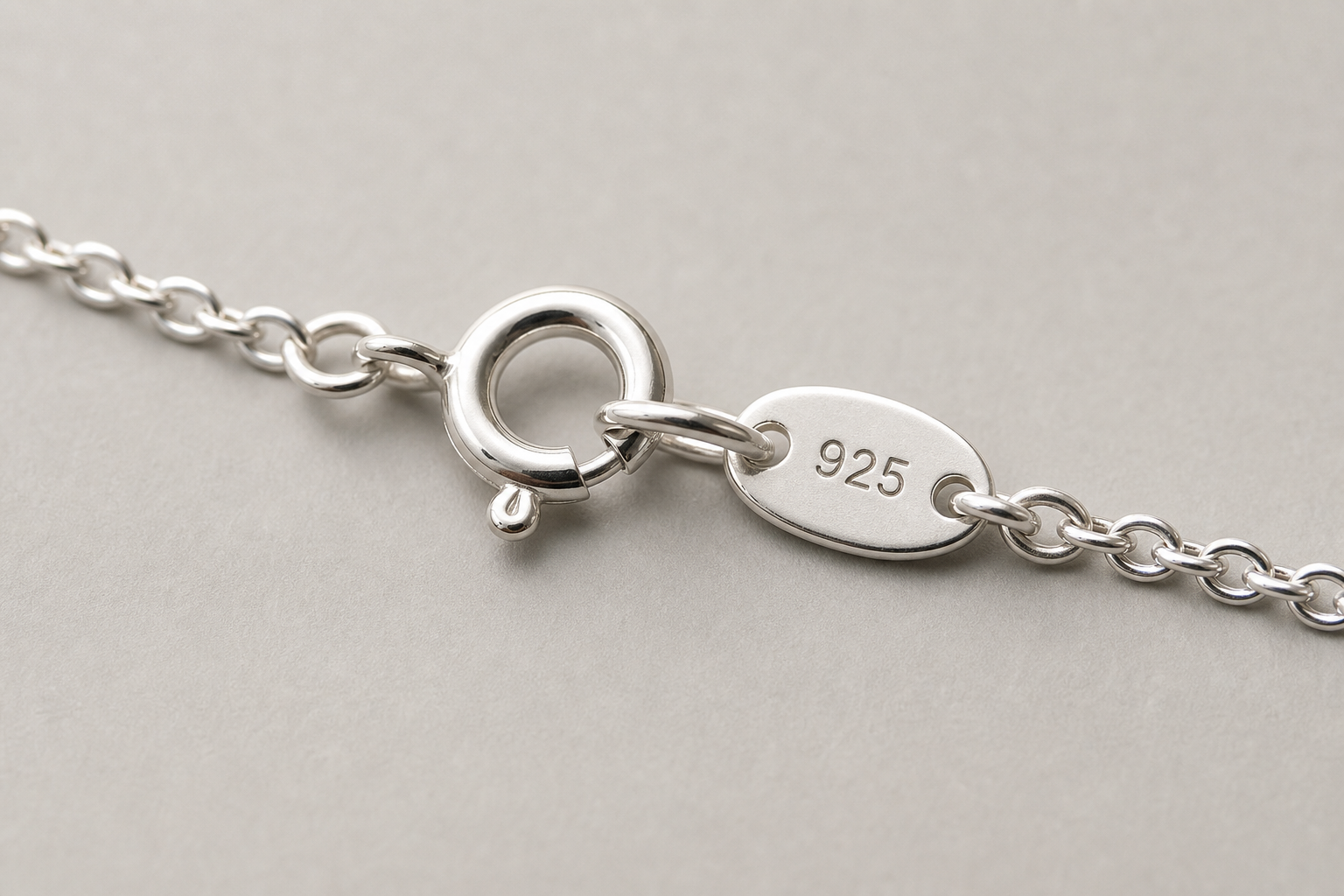 Close-up of a sterling silver necklace clasp with a 925 stamp