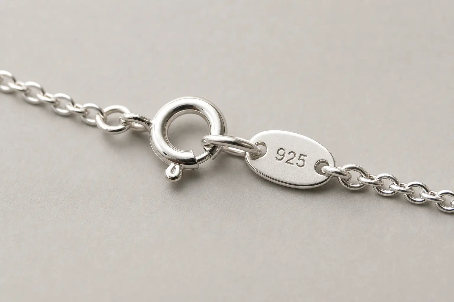 Close-up of a sterling silver necklace clasp with a 925 stamp